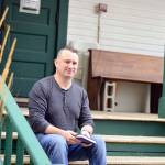 Joe Gillard of Quilcene, pictured on the steps of the Centrum building where he works, is author of The Little Book of Lost Words. (Diane Urbani de la Paz/Peninsula Daily News)