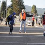 Bus driver Veronica Brenner, center, and paraeducator Liz Joers direct students to classrooms at Helen Haller Elementary and buses to Greywolf Elementary on Wednesday morning for the first day of school. (Matthew Nash/Olympic Peninsula News Group)