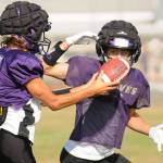 Sequim senior quarterback Kobe Applegate, left, prepares to hand off the football to Aiden Gockerell during a recent practice. The Wolves visit Forks tonight at 7 p.m. in the season opener for each school. (Michael Dashiell/Olympic Peninsula News Group)