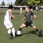 Peninsula Colleges Tim Deser (23) fights for the ball with Wenatchee Valleys Sebastian Aviles on Sunday afternoon at Wally Sigmar Field. The Pirates won 3-0 behind three goals in the second half. (Dave Logan/for Peninsula Daily News)