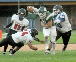 Keith Thorpe/Peninsula Daily News Port Angeles Daniel Cable, center, weaves around East Jefferson defenders, from left, Malachi Azariah McDonald, Gerald Lindsey and Christopher Fair on Friday in Port Angeles.