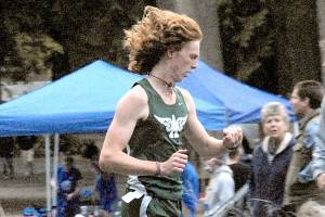 Jack Gladfelter of Port Angeles checks his watch for an intermediate time before going on to win the varsity boys cross-country race at Lincoln Park in Port Angeles on Wednesday. (Keith Thorpe/Peninsula Daily News)