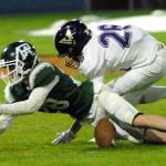 Keith Thorpe/Peninsula Daily News Port Angeles receiver Brantyn Fisler, left, gets the ball knocked away by North Kitsaps Karsen Walsh during Friday nights game at Port Angeles Civic Field.