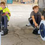 Lukas Teague of Port Angeles and Grady White of Port Townsend battle it out on the second of three events in the Little Hurt Triathlon on Sunday at Lincoln Park in Port Angeles. The events included 10 laps on the Lincoln Park BMX track, a 2,000-meter row on rowing machines, and a 1.9-mile run. Both eighth-graders led various legs of their seventh- and eighth-grade heat, with White pulling ahead on the final leg. Teague finished within a minute of the overall champion for second place. Both boys also compete for their respective middle school cross-country teams.
