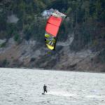 In what he called a good frisky breeze, Josh Porter of Port Townsend kiteboards across the Salish Sea beside Fort Worden State Park. (Diane Urbani de la Paz/Peninsula Daily News)