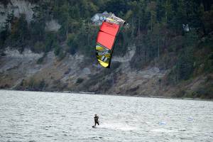 In what he called a good frisky breeze, Josh Porter of Port Townsend kiteboards across the Salish Sea beside Fort Worden State Park. (Diane Urbani de la Paz/Peninsula Daily News)