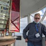 Frank Bruni, a volunteer at the Point Wilson Light Station with the U.S. Lighthouse Society, helped conduct tours of the lantern room at the top of the lighthouse on Tuesday as part of an open house of the facilities. The organization is moving into the next stage of renovations, starting with the roof of the keepers dwelling. (Zach Jablonski/Peninsula Daily News)