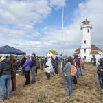 About 100 people attended the kickoff and open house of the Point Wilson Light Station Preservation Project conducted by the U.S. Lighthouse Society. During the ceremony, members of the Port Gamble SKlallam Tribe gave a blessing and song, officials spoke to the importance of the project and steps taken so far, and then attendees toured the lighthouse and other facilities. (Zach Jablonski/Peninsula Daily News)