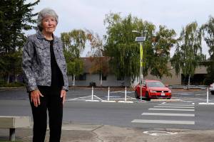 JoVonne Lingvall stands by a new pedestrian crosswalk at St. Josephs Catholic Church where she and her sister were struck by a vehicle last November. Lingvall survived, but her sister Lorraine (Reandeau) Anderson died four days later. (Matthew Nash/Olympic Peninsula News Group)