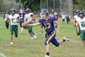 Steve Mullensky/for Peninsula Daily News


Ranger Kevin Alejo extends the ball over the plane of the goal line for a touchdown during a Thursday afternoon game home game against the Muckleshoot Kings.