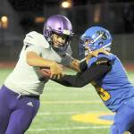 Michael Dashiell/Olympic Peninsula News Group
Sequim quarterback Lars Wiker, left, tries to avoid the grasp of a Bremerton defender in the Wolves' 35-29 loss at Bremerton on Thursday.