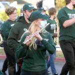 Port Angeles High School sophomore Madeline Irwin, center, plays flute through a hole in her mask with other members of the schools marching band at the start of Fridays homecoming parade from the Clallam County Courthouse to Port Angeles Civic Field. The Port Angeles Roughriders were defeated by the Kennedy Catholic Lancers 40-7 in Friday nights football game. (Keith Thorpe/Peninsula Daily News)