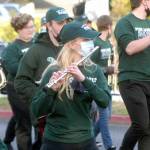 Port Angeles High School sophomore Madeline Irwin, center, plays flute through a hole in her mask with other members of the schools marching band at the start of Fridays homecoming parade from the Clallam County Courthouse to Port Angeles Civic Field. The Port Angeles Roughriders were defeated by the Kennedy Catholic Lancers 40-7 in Friday nights football game. (Keith Thorpe/Peninsula Daily News)