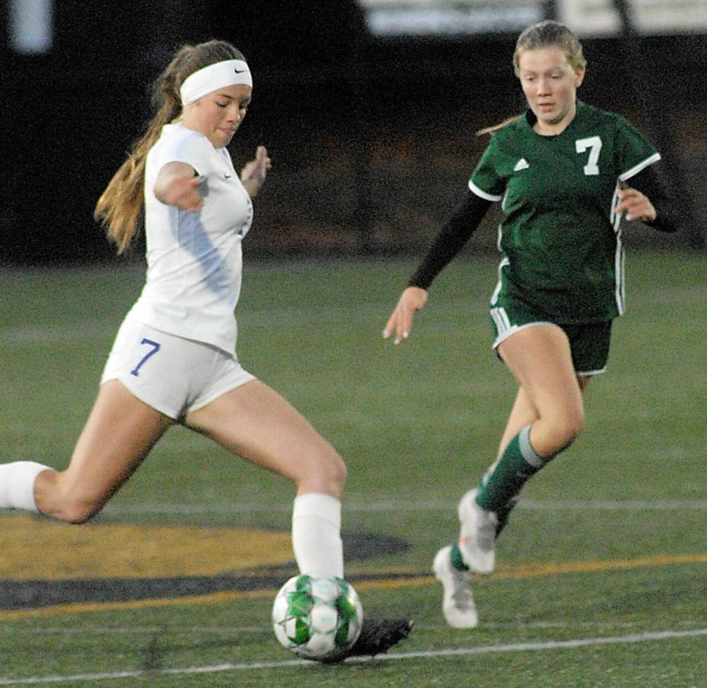 Sequims Bailey Genessie, left, tries to out pace Port Angeles Izzy Felton during Tuesdays match at Peninsula College in Port Angeles. (Keith Thorpe/Peninsula Daily News)