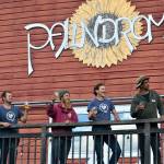 Taking a break from setting up for the Olympic Peninsula Apple & Cider Festival, four Production Alliance crew members  from left, Danny Milholland, Shane Parish, Larry Lawrence and Damon Barlow  look out over the orchard at Eaglemount Winery-Cidery of Port Townsend. (Diane Urbani de la Paz/Peninsula Daily News)