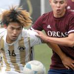 Peninsula's Hayahide Sakamoto, front left, and Whatcom's Juan Obeso eye a loose ball on Saturday at Peninsula College. Behind Sakamoto is teammate Jeong Hyun Kang. (Keith Thorpe/Peninsula Daily News)