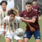 Peninsulas Hayahide Sakamoto, front left, and Whatcoms Juan Obeso eye a loose ball on Saturday at Peninsula College. Behind Sakamoto is teammate Jeong Hyun Kang. (Keith Thorpe/Peninsula Daily News)