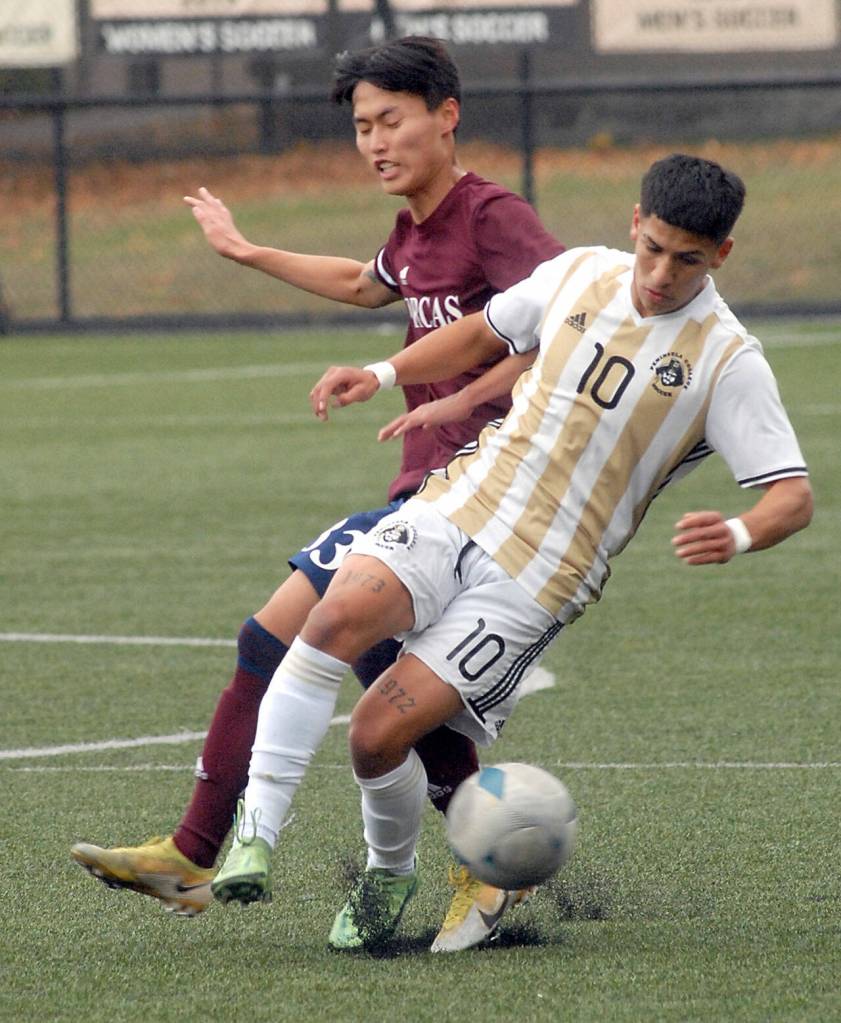 Peninsulas Fernando Tavares, front, cuts off a pass intended for Whatcoms Donghyeon Kim on Saturday in Port Angeles. (Keith Thorpe/Peninsula Daily News)