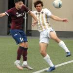 Peninsulas Kai Biegler, right, struggles to keep the ball inbounds as Whatcoms Nate Balauro looks on during Saturdays match in Port Angeles. (Keith Thorpe/Peninsula Daily News)