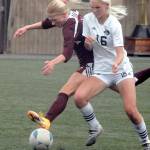 Peninsulas Millie Long, right, battles for control with Whatcoms Eden Fawcett during the first half of Fridays match in Port Angeles. (Keith Thorpe/Peninsula Daily News)