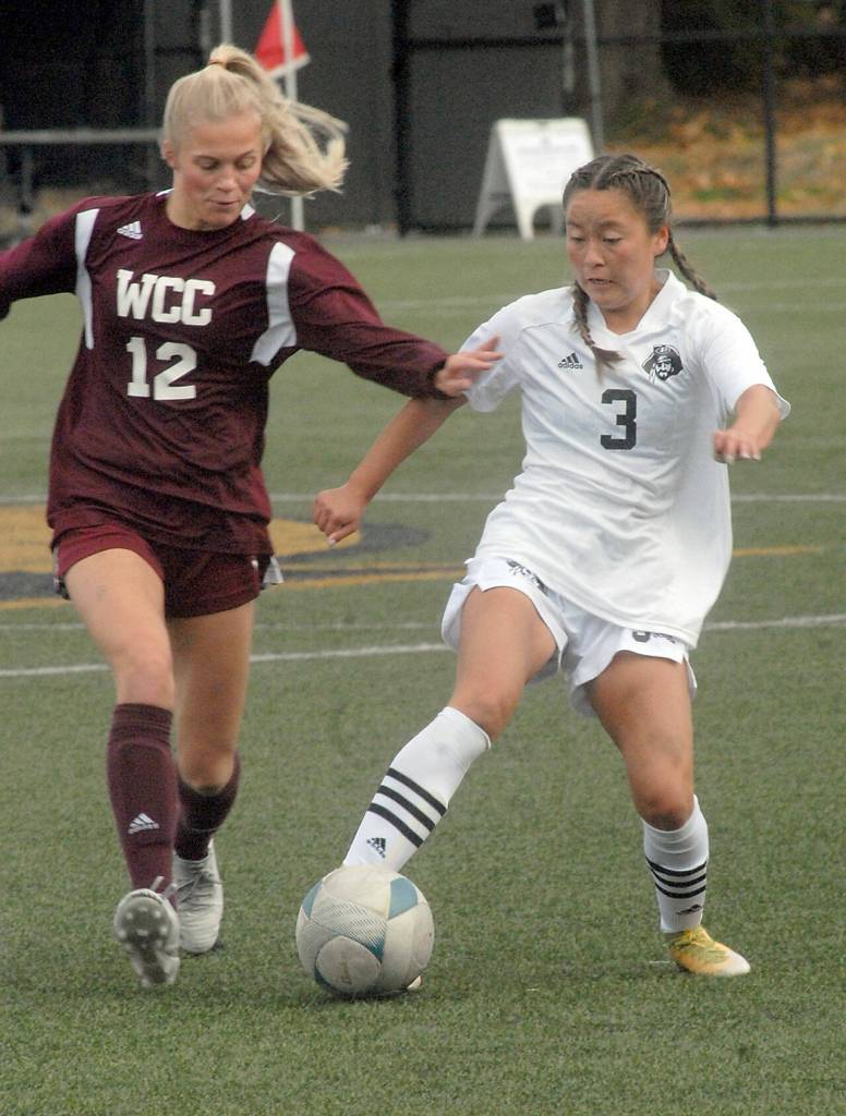 Peninsulas Shayanne Chang tries to evade Whatcoms Keylie Hershey on Saturday in Port Angeles. (Keith Thorpe/Peninsula Daily News)