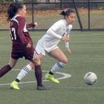 Peninsulas Chiaki Takase, right, races past the defense of Whatcoms Piper Parish on Saturday at Wally Sigmar Field in Port Angeles. (Keith Thorpe/Peninsula Daily News)