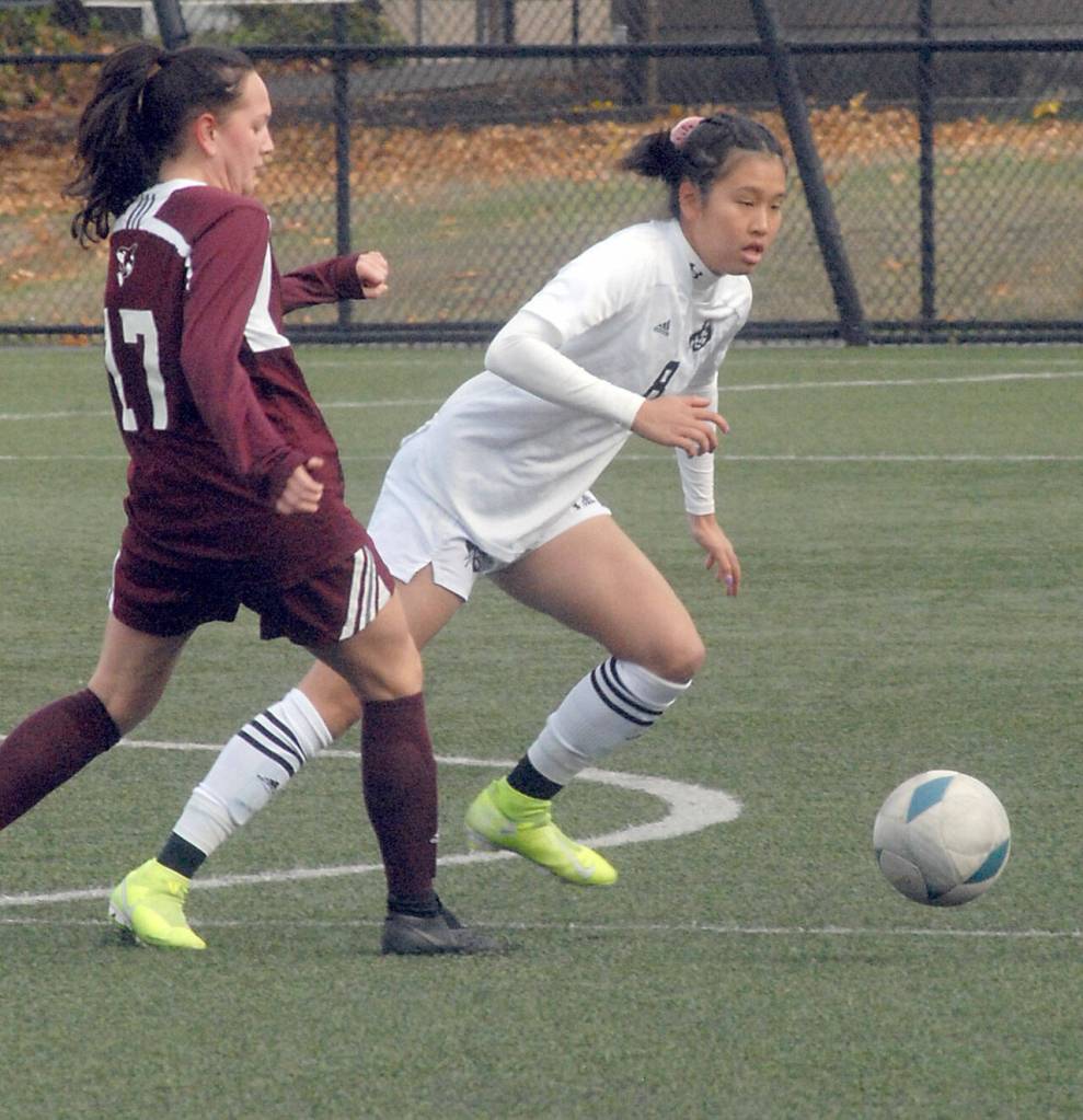 Peninsulas Chiaki Takase, right, races past the defense of Whatcoms Piper Parish on Saturday at Wally Sigmar Field in Port Angeles. (Keith Thorpe/Peninsula Daily News)