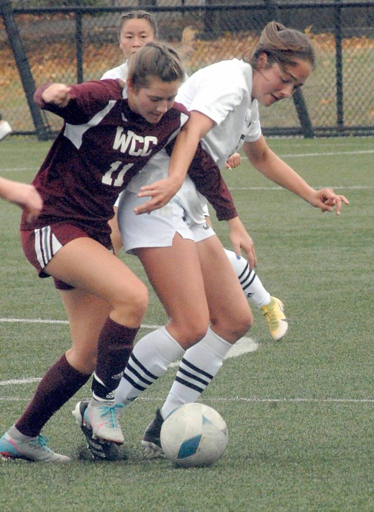 Whatcoms Alana Sullivan, left, and Peninsulas Kascia Muscutt battle for ball control on Saturday in Port Angeles. (Keith Thorpe/Peninsula Daily News)