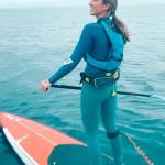 Hannah Nelson of Port Angeles stands on her paddleboard, which she calls her rocket ship because its red. (Laura Hall)