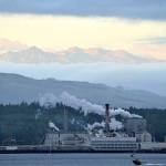 Soon after dawn, clouds part to reveal the Olympic Mountains high above the Port Townsend Paper mill from the Washington State Ferry dock in Port Townsend. Sunrise will come about 90 seconds later each morning through the solstice on Dec. 21. (Diane Urbani de la Paz/Peninsula Daily News)