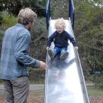 Keith Thorpe/Peninsula Daily News
Glen Wade of Port Angeles encourages his son, Yuli Schutz-Wade, 2 1/2, to go down a tall slide on Thursday on the playground at Dungeness Recreation Area north of Sequim. The area is a popular spot to camp and hike, and provides access to Dungeness Spit and the Dungeness National Wildlife Refuge.