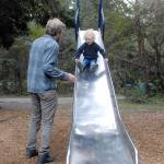 Glen Wade of Port Angeles encourages his son, Yuli Schutz-Wade, 2 1/2, to go down a tall slide on Thursday on the playground at Dungeness Recreation Area north of Sequim. The area is a popular spot to camp and hike, and provides access to Dungeness Spit and the Dungeness National Wildlife Refuge. (Keith Thorpe/Peninsula Daily News)