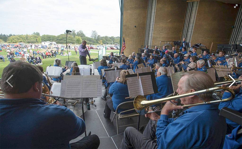 A view from the trombone section of the Sequim City Band, with director Tyler Benedict during the concert Aug. 22, 2021. (Jesse Major /Jesse Major Photography)