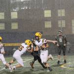 image 11=Spartan running back Nate Dahlgren (40) picks up more big yardage behind the blocking of Conner Earls (56) and Kalab Blanton (11),  It was a big night for both the Forks offense and defense against the Morton-White Pass Timberwolves on Homecoming Night at Spartan Stadium..  Photo by Lonnie Archibald.