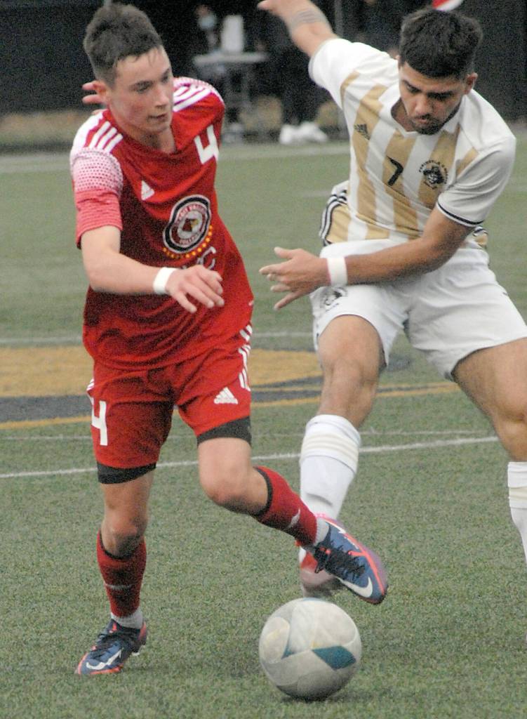 Skagit Valleys Aurelien Habasque, left, and Peninsulas Jonathan DeMotto race for ball control on Wednesday at Peninsula College. (Keith Thorpe/Peninsula Daily News)