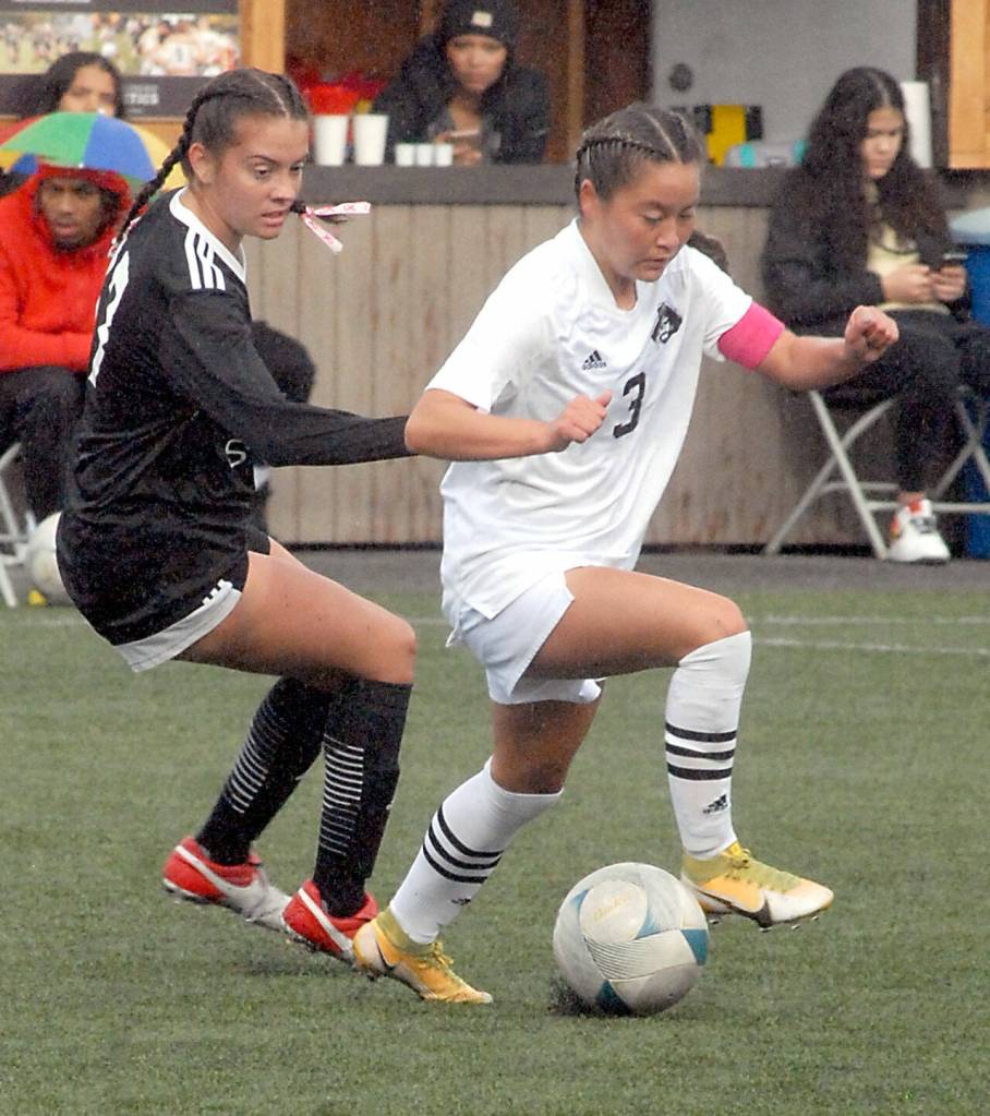 Peninsulas Shyanne Chang, right, avoids the defense of Skagit Valleys Sierrah Esson during Wednesdays match at Wally Sigmar Field in Port Angeles. (Keith Thorpe/Peninsula Daily News)
