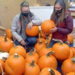 Keith Thorpe/Peninsula Daily News
Rachel Storck, community outreach coordinator for the Port Angeles Fine Arts Center, left, and executive director Christine Loewe look over pumpkins to be available for carving during this weekend's Celebration of Shadows Fall Festival.