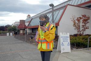 Ham radio operator Kathleen Reiter, training coordinator for Amateur Radio Emergency Services, relays radio messages outside the county courthouse during Thursdays Great ShakeOut, an international drill to practice how to drop, cover and hold in the event of an earthquake. In Clallam County, numerous schools and other agencies practiced what to do in an emergency. Included in the drill was the sounding of tsunami sirens across the state. (Keith Thorpe/Peninsula Daily News)