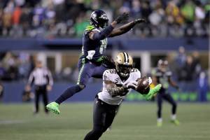 New Orleans Saints' Demario Davis (56) breaks up a pass intended for Seattle Seahawks' DK Metcalf in the final minute the second half of an NFL football game, Monday, Oct. 25, 2021, in Seattle. The Saints won 13-10. (AP Photo/John Froschauer)