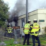 Clallam County Fire District 2 firefighters work to extinguish a blaze in a single-wide house trailer on the 2400 block of East Pioneer Road in Gales Addition east of Port Angeles on Tuesday. (Keith Thorpe/Peninsula Daily News)
