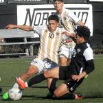 Peninsulas Fernando Tavares, center, fights off a tackle by Everetts Carlos Rodriguez as Tavares teammate, Juan Carlos Hernandez, looks on during Saturdays match at Wally Sigmar Field in Port Angeles. (Keith Thorpe/Peninsula Daily News)