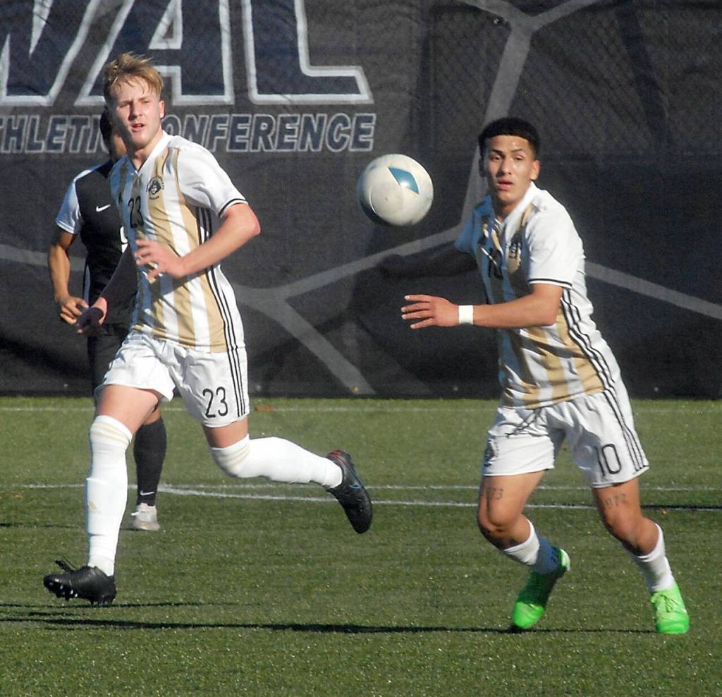 Peninsulas Tim Deser, left, and Fernando Tavares try to control a loose ball as Everetts Axel Rochel follows behind on Saturday in Port Angeles. (Keith Thorpe/Peninsula Daily News)