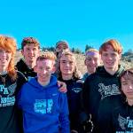 Port Angeles cross-country runners, from left Jack Gladfelter, Naaman McGuffey, Langdon Larson, Coach Rodger Johnson, Kowen Kasten, Josh Gavin, Jason Gladfelter and Max Baeder won the District 3 championship this weekend and qualified for the state 2A meet. (Courtesy photo)