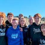 Port Angeles cross-country runners, from left Jack Gladfelter, Naaman McGuffey, Langdon Larson, Coach Rodger Johnson, Kowen Kasten, Josh Gavin, Jason Gladfelter and Max Baeder won the District 3 championship this weekend and qualified for the state 2A meet. (Courtesy photo)