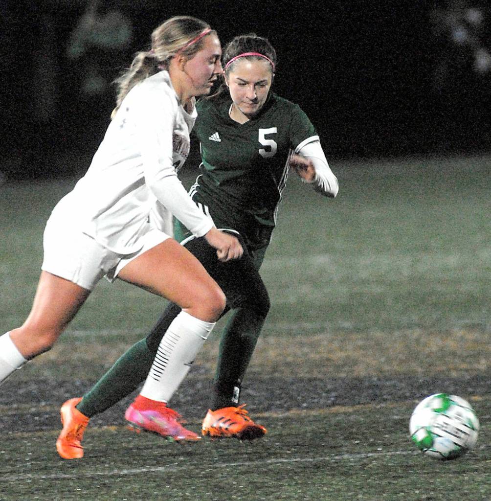 Enumclaws Lauren Boger, left, and Port Angeles Mia Gagnon go after the ball on Tuesday night in Port Angeles. (Keith Thorpe/Peninsula Daily News)
