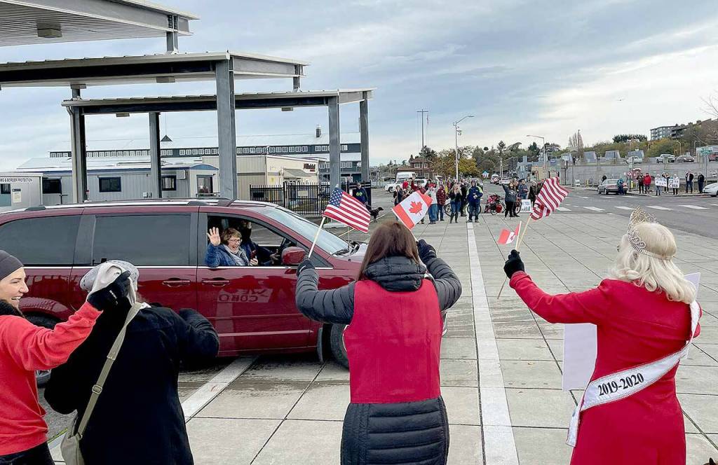 Arrivals from Victoria were all smiles as a large group gathered in Port Angeles to show just how much they missed their neighbors from across the Strait of Juan de Fuca. With cheers and music, Port Angeles welcomed the Black Ball Ferry Line M/V Coho ferry as it resumed its service Monday after a 20-month hiatus. (Scott Gardinier/Peninsula Daily News)