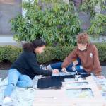 Teen leaders Ava Hubbard, of Port Townsend, on the left, and Briangela Vanwart, of Sequim, paint scenery in preparation for the Rocky Railroad Kids Night	(Nathan Byers/Sequim Adventist Church)