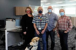 Some of the staff at WorkSource Clallam County stand in the resource lab where locals will soon be able to work on resumes, send emails and more as they seek new work. Pictured staff, include, from left, Claire Weaver, trade act, WIOA adult and dislocated worker for Clallam, Jefferson and Kitsap counties; Jon Ferguson, veterans employment specialist, with Professor the dog;  John Krouse, strategies for success instructor; and Brandino Gibson, supervisor. (Matthew Nash/Olympic Peninsula News Group)