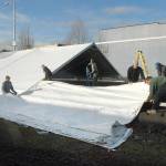 A work crew erects a tent on Wednesday that will cover a temporary ice skating rink to be installed for the annual Winter Ice Village in the 100 block of West Front Street in downtown Port Angeles. Daily ice skating will begin on Nov. 19 and continue through Jan. 3. (Keith Thorpe/Peninsula Daily News)