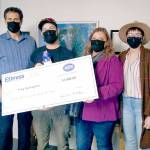 Troy Gallagher of Port Angeles, second from left, accepts a $1,000 jackpot from Express Employment Professionals employees Duane Folden, left, Shelley Mills and Kendra Lucke. Gallagher is one of 24 jackpot winners from across the country. The firm has 830 offices and more than 500,000 employees nationwide.